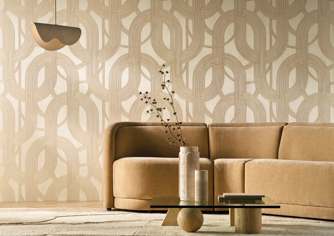 Tan sofa against a patterned wallcovering