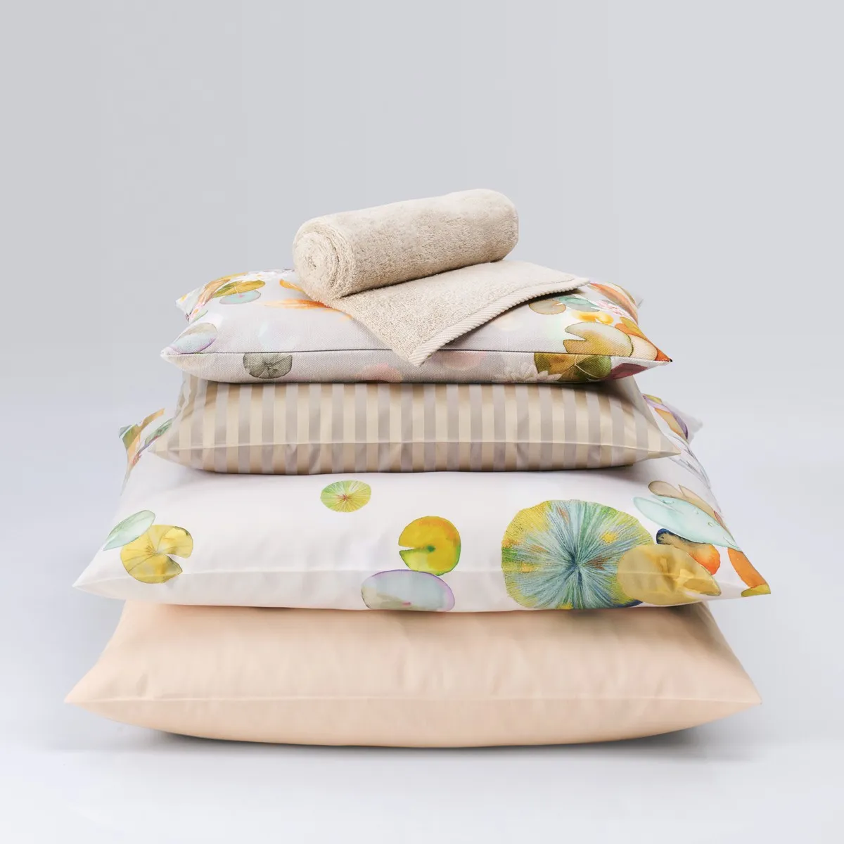 Stack of printed bedlinen and cushions