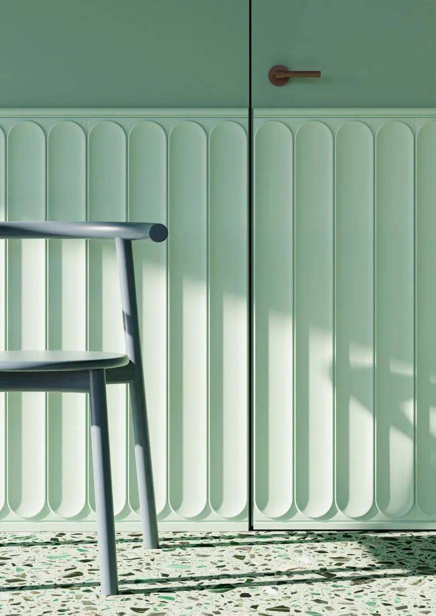 Mint green fluted cabinet doors beside a dark wooden chair